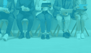 Diverse team of professionals sitting with tablets and laptops.