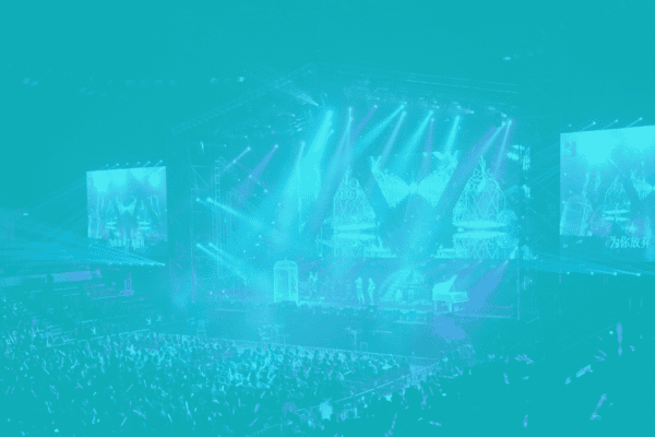 Concert stage with vibrant lighting and large screens at a live event.
