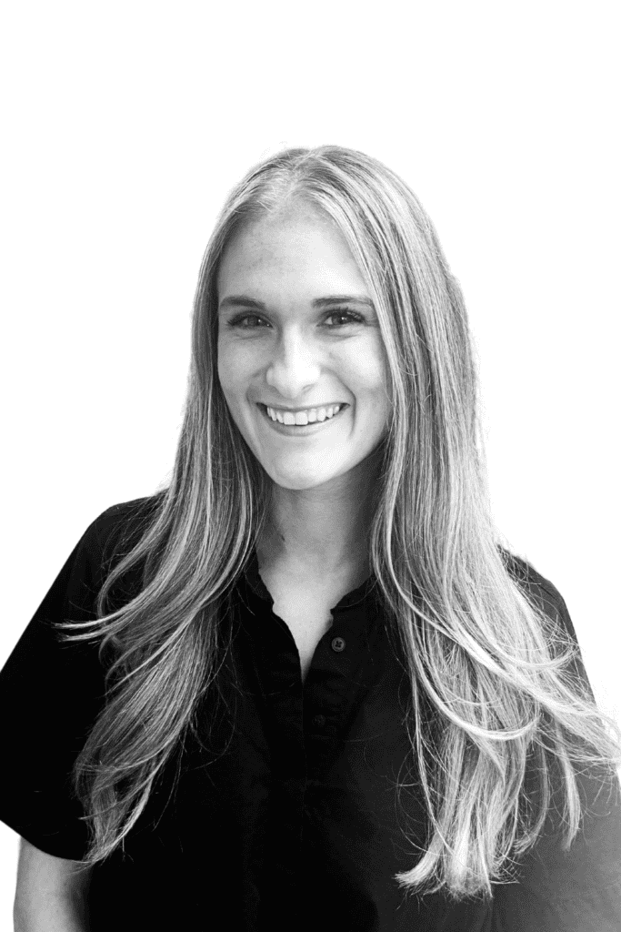 Smiling woman with long hair in a professional black shirt.