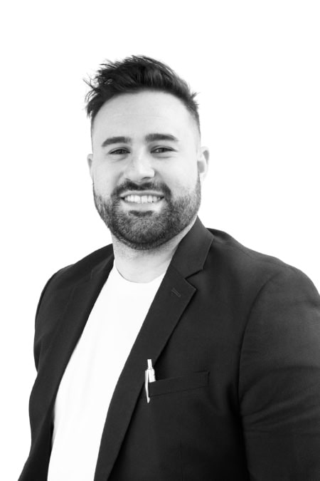 Professional portrait of a smiling man in a suit for BlueWave Resource Partners.