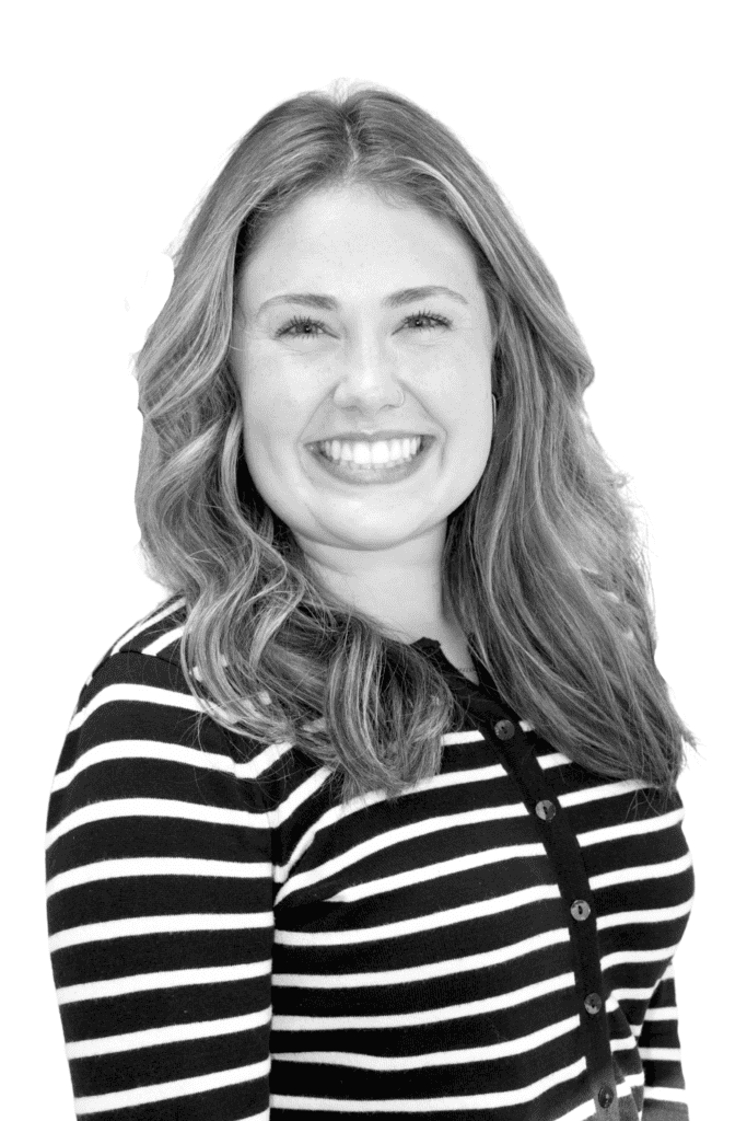 Smiling woman with wavy hair in striped shirt for BlueWave Resource Partners.