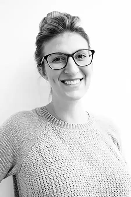 Professional woman with glasses smiling, representing BlueWave Resource Partners.