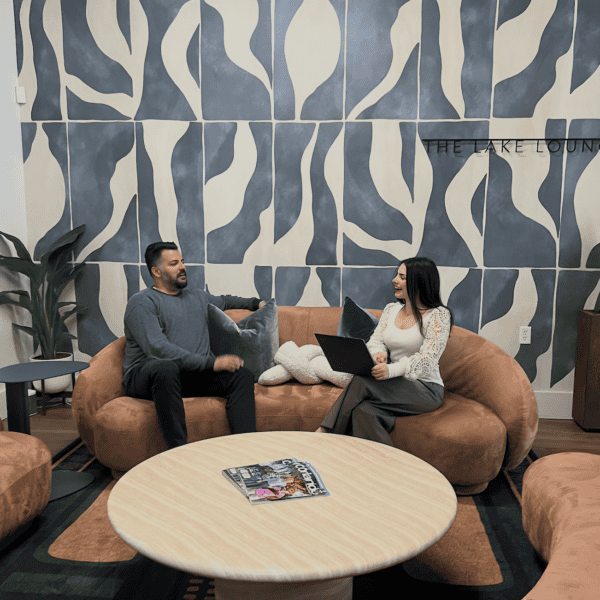 Business professionals discussing in a modern lounge setting.