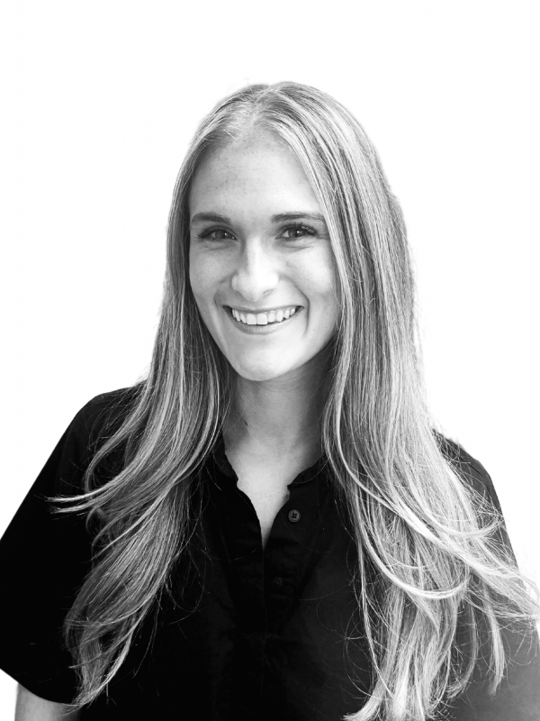 Smiling woman with long hair in a professional black shirt.