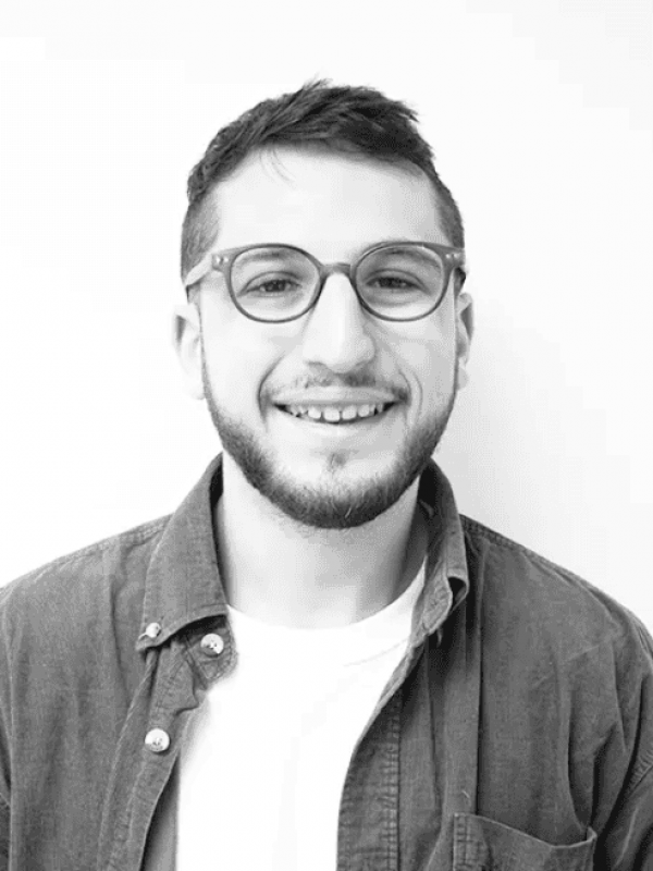 Portrait of Ross Bernstein, smiling man with glasses, in professional setting.