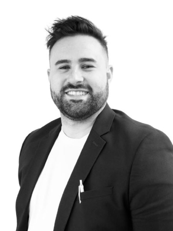 Professional portrait of a smiling man in a suit for BlueWave Resource Partners.