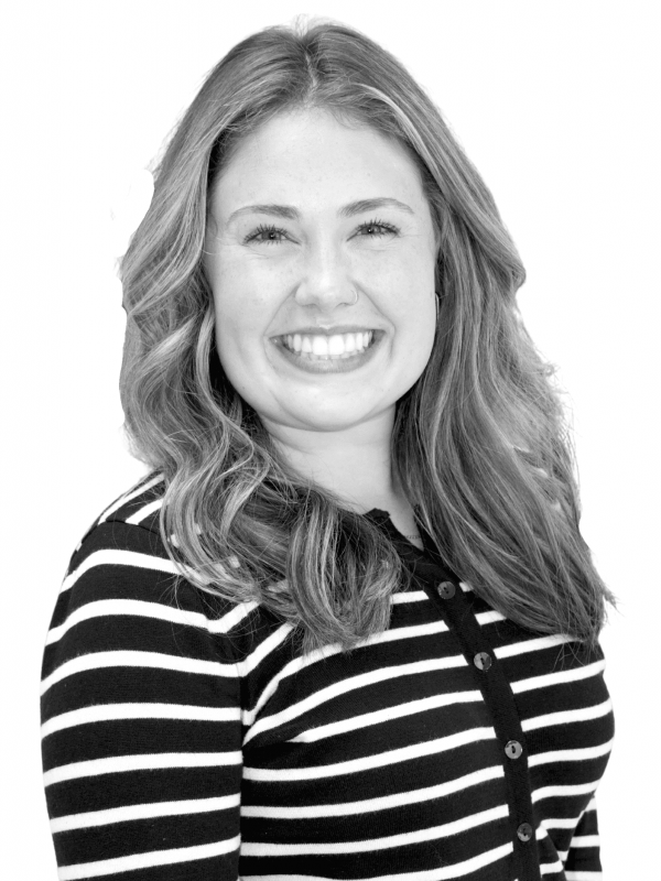 Smiling woman with wavy hair in striped shirt for BlueWave Resource Partners.
