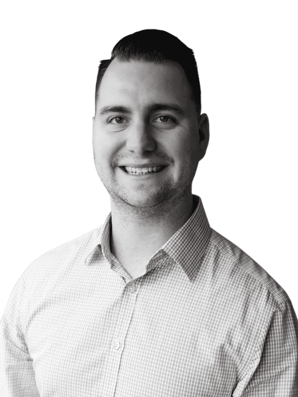 Professional portrait of a smiling man in business attire.
