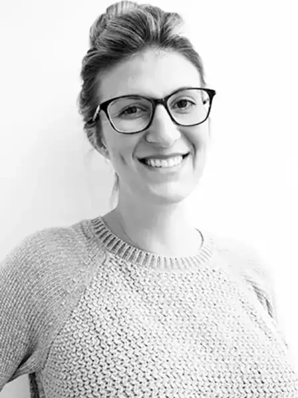 Professional woman with glasses smiling, representing BlueWave Resource Partners.